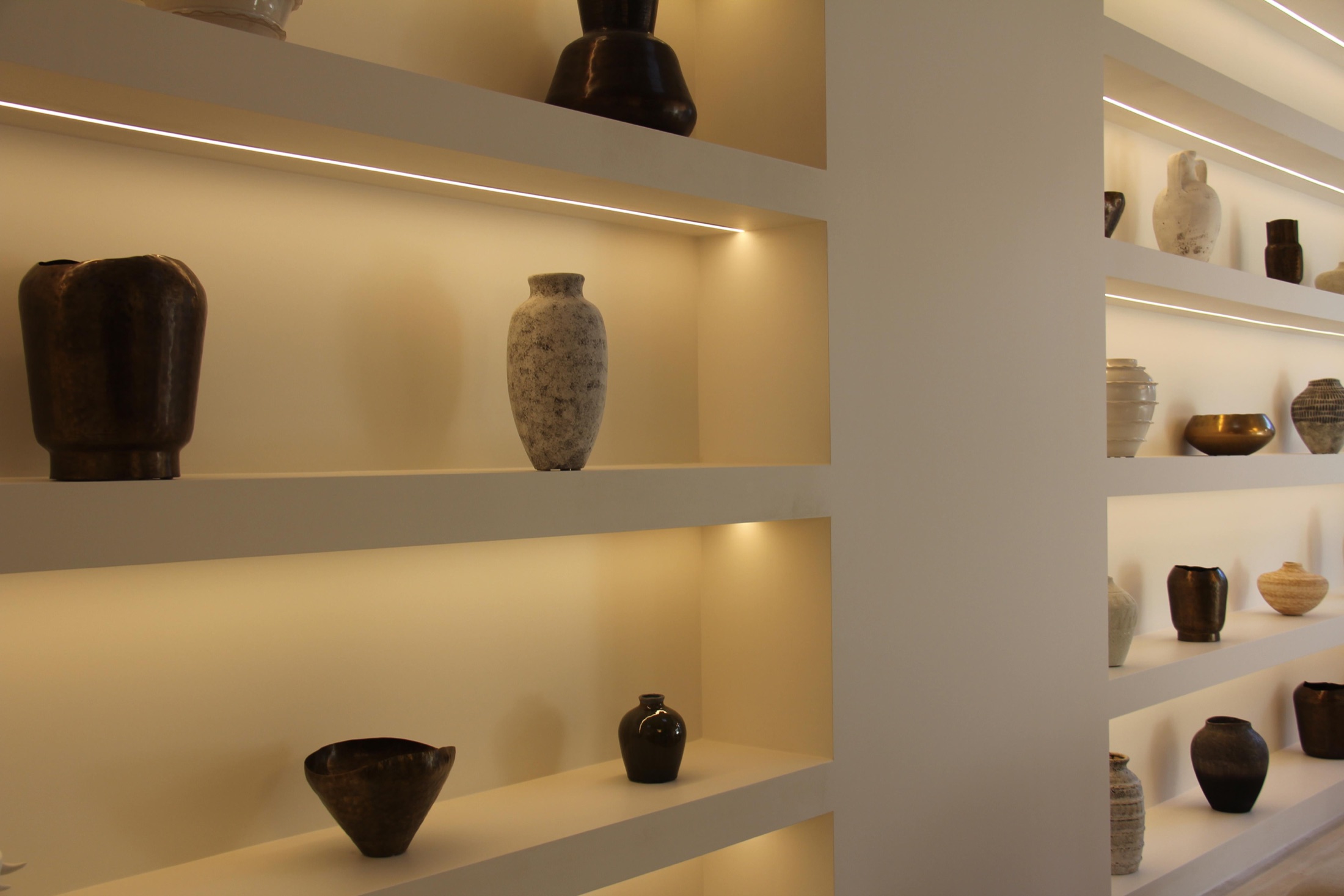 Lighting channels built into the shelf returns
